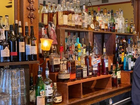 a person drinking a shelf in a store filled with wine glasses