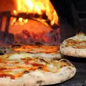 a pizza sitting on top of a pan on a stove